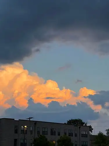 Golden clouds meet stormy skies.